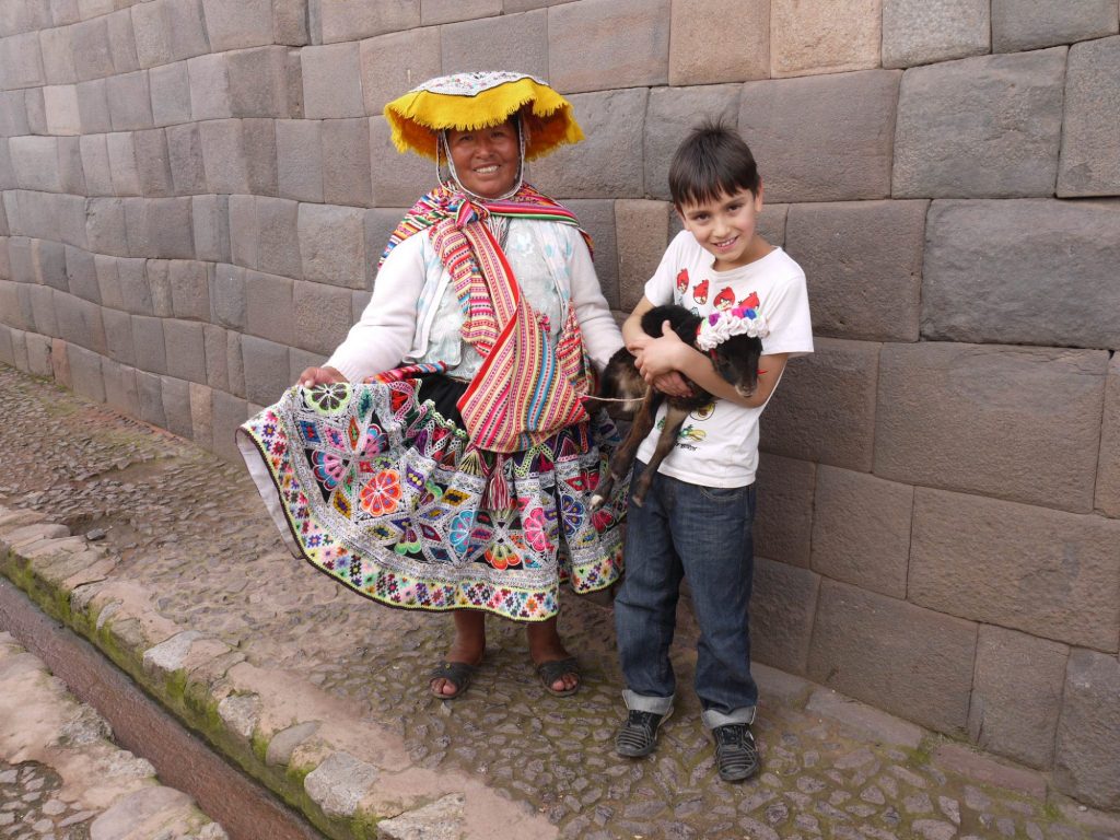 Pisac lady and Child with Lamb Cusco Peru