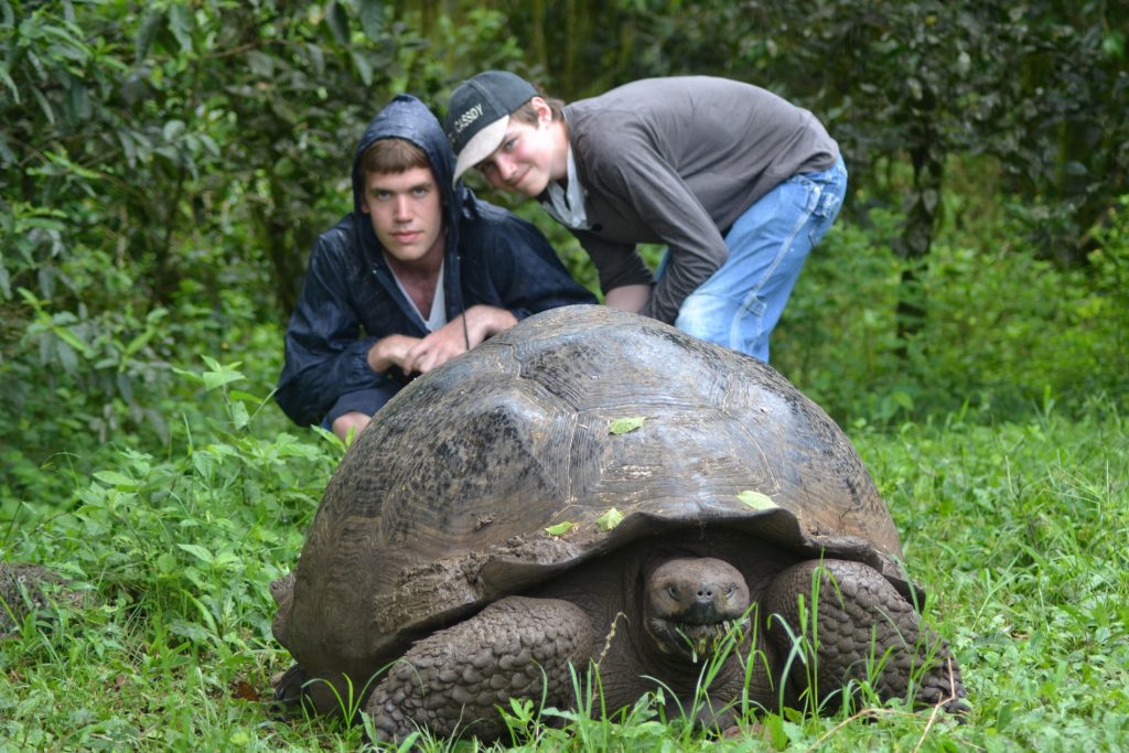 Kids with giant tortoises Family holiday Galapagos