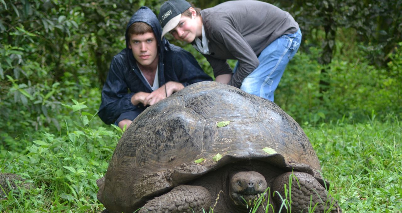 Kids with giant tortoises Family holiday Galapagos