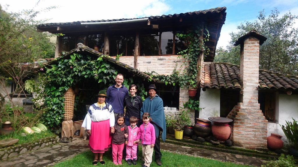 Ecuador San Clemente family and hosts outside house