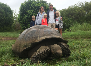 Family with giant tortoise Galapagos