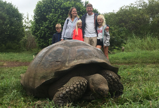 Family with giant tortoise Galapagos
