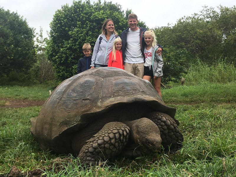 Family with giant tortoise Galapagos