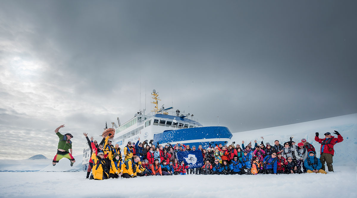 crew and passengers with their boat in Antarctica