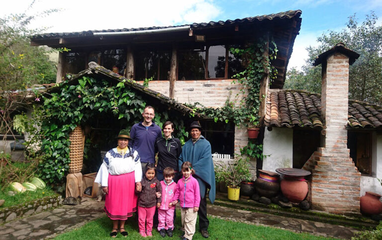 Ecuador San Clemente family and hosts outside house