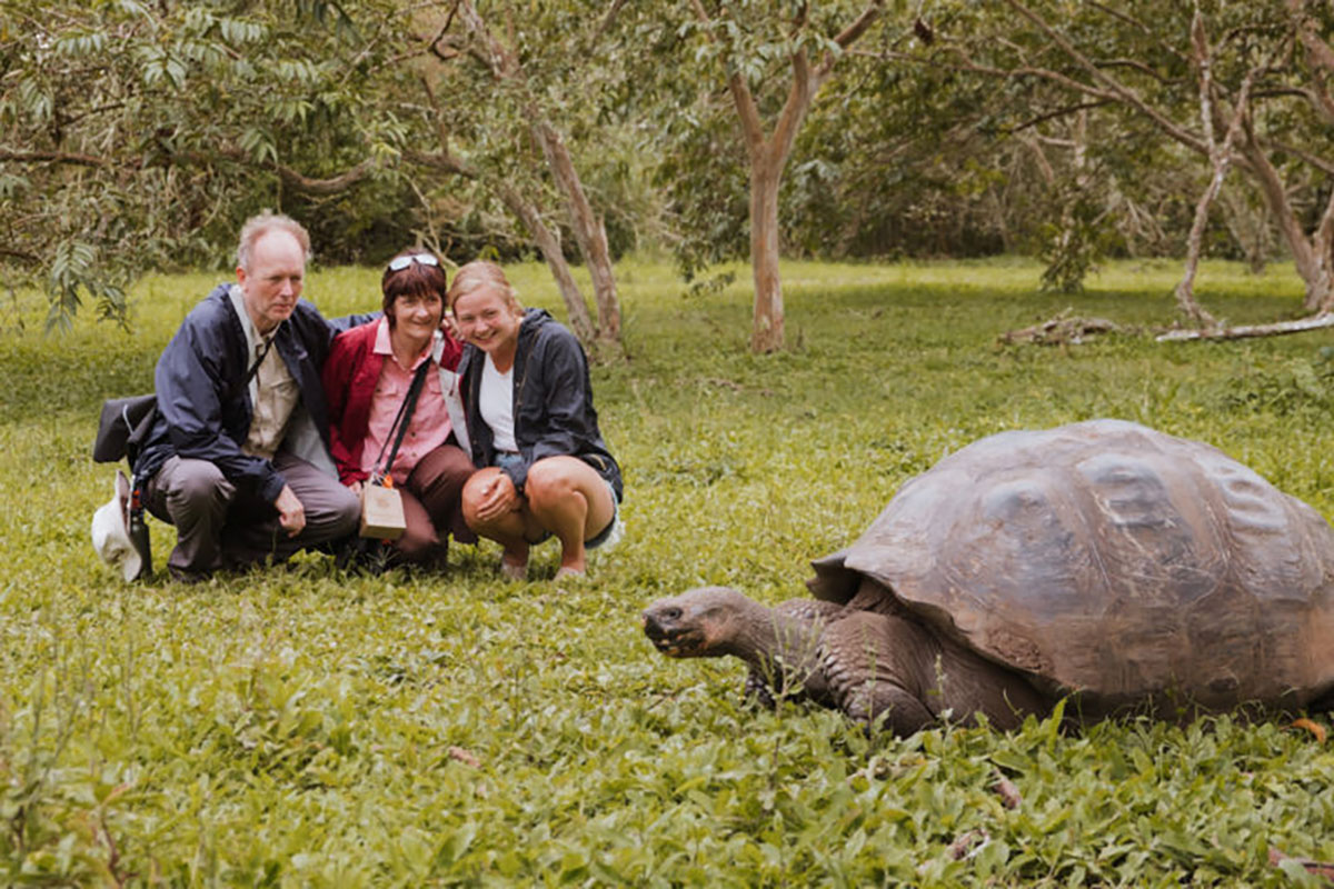 People Watching A Giant Tortoise Santa Cruz Galapagos Islands