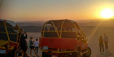 Dune sunset and buggy Huacachina Peru