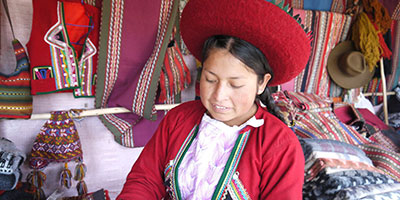 weaver in traditional dress peru